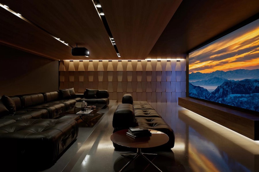 high-end luxury home theater featuring couch seating, a 4K projector, and an ALR projection screen.