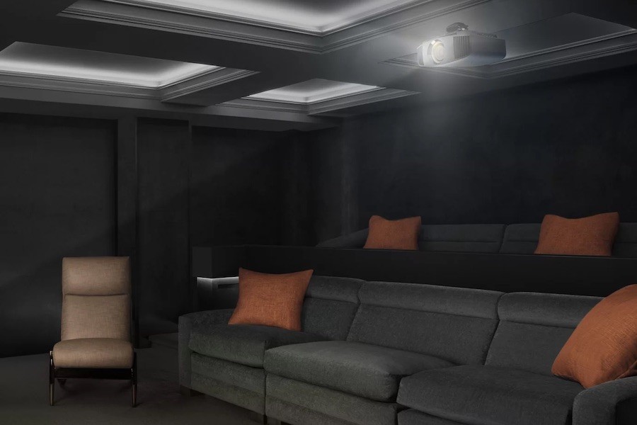 A dark-toned home theater with plush seating, projector, and decorative ceiling features.